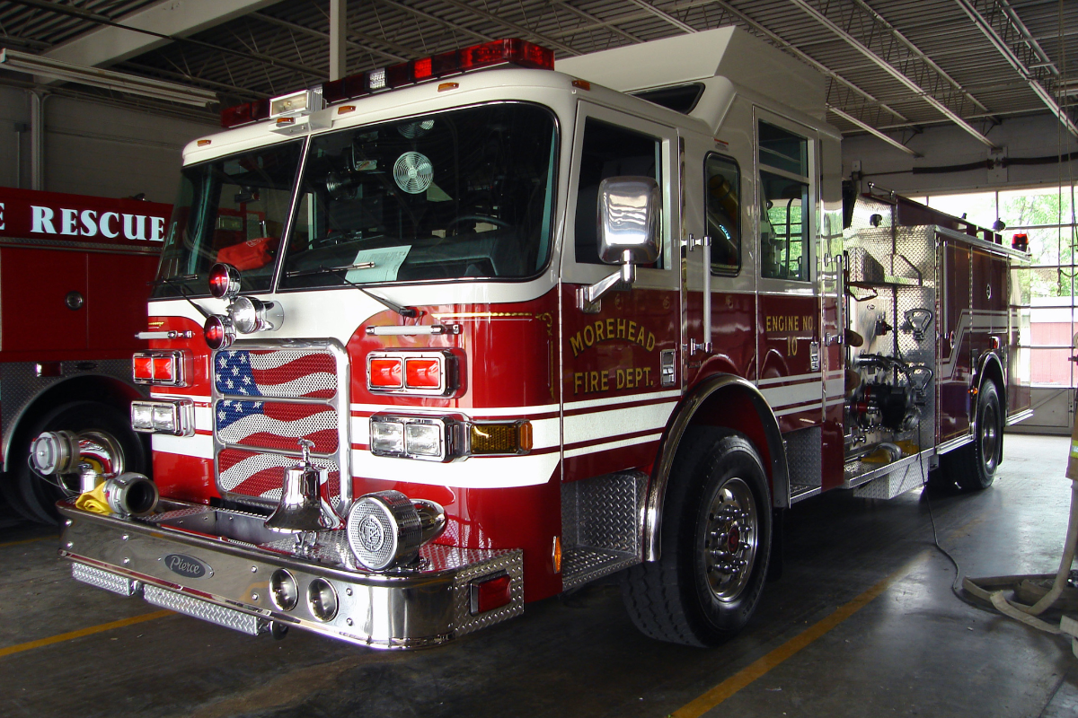 Morehead fire department red fire truck with an American flag on the front