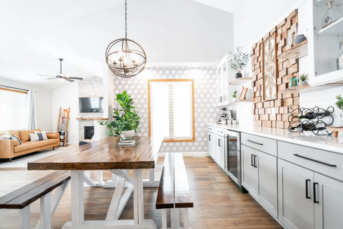 Shaker buffet cabinets with gray base cabinets and white glass cabinets above with wood floating shelves