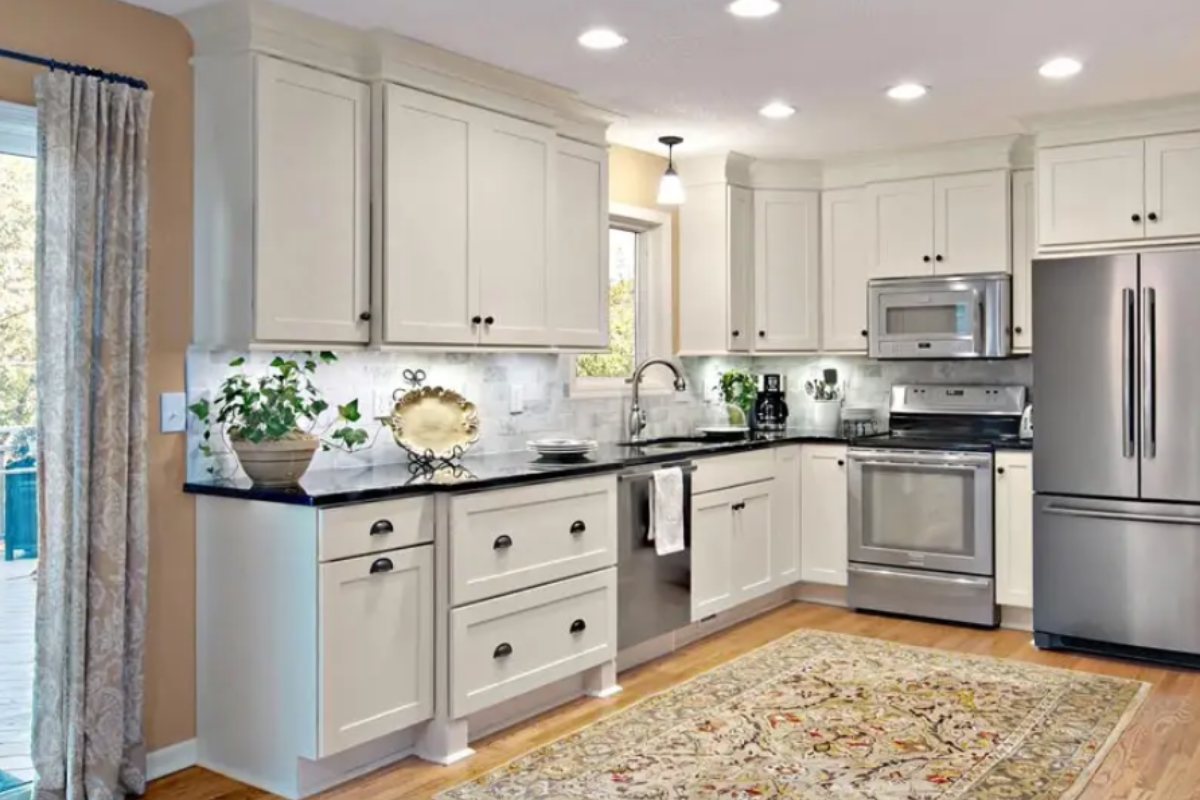 White shaker kitchen cabinets with a bump-out drawer base and decorative feet