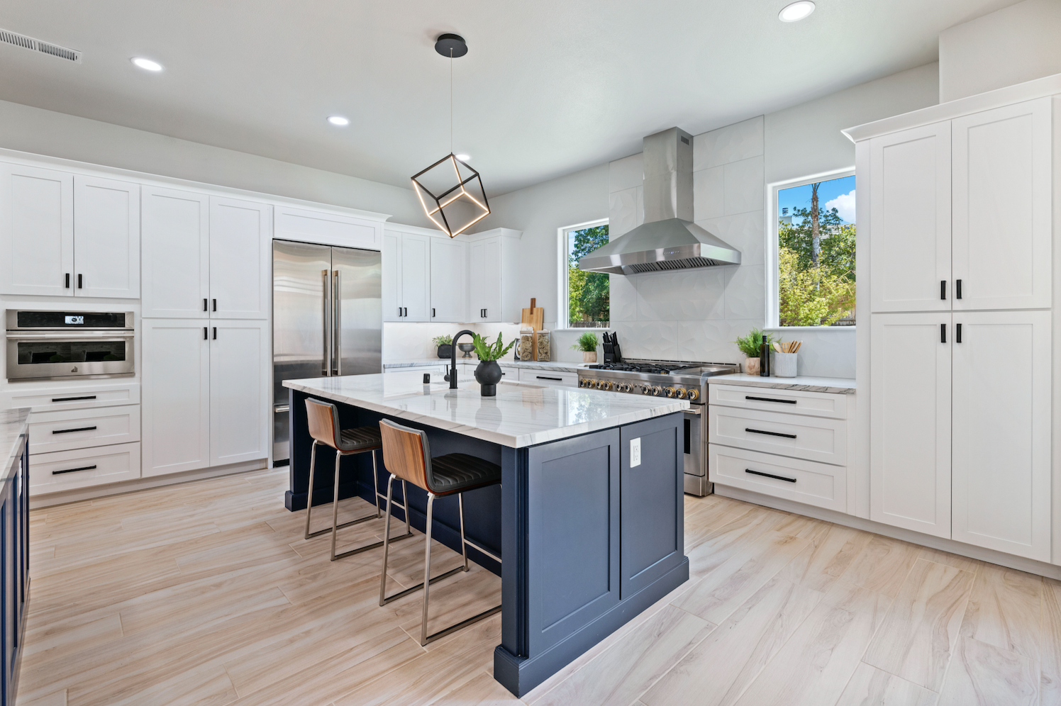 CliqStudios project: White shaker kitchen with two navy blue kitchen islands