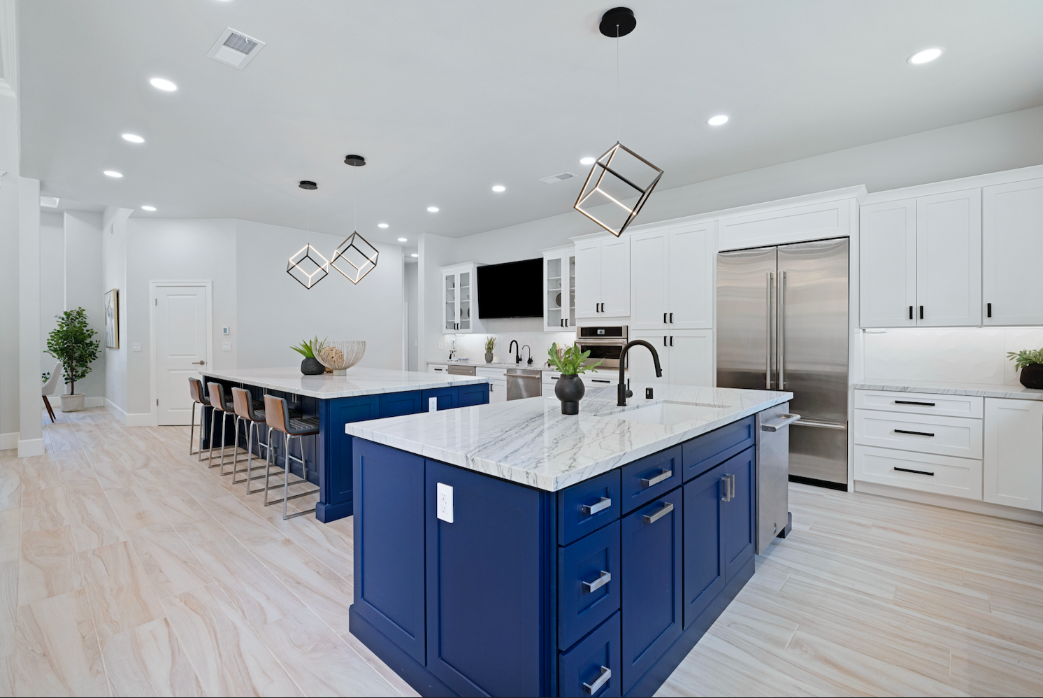 CliqStudios project: White shaker kitchen with two navy blue kitchen islands