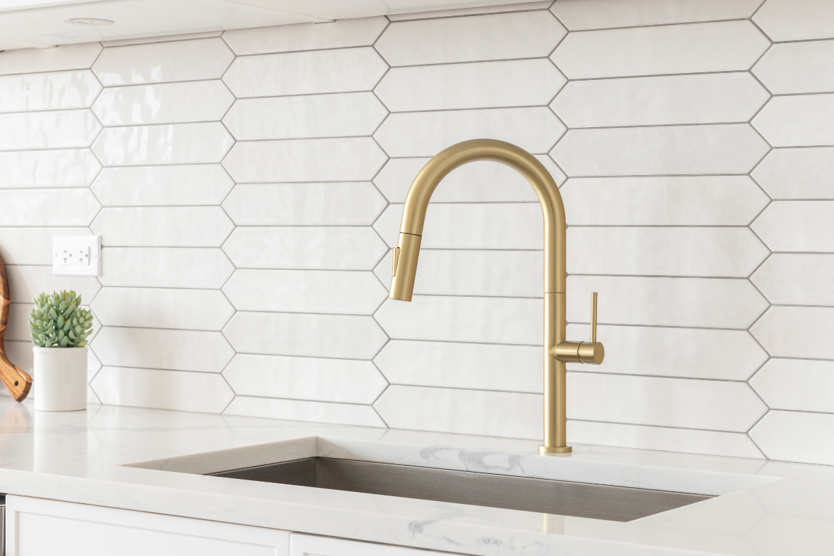 Shiny white tile backsplash with a gold faucet Shiny white tile backsplash