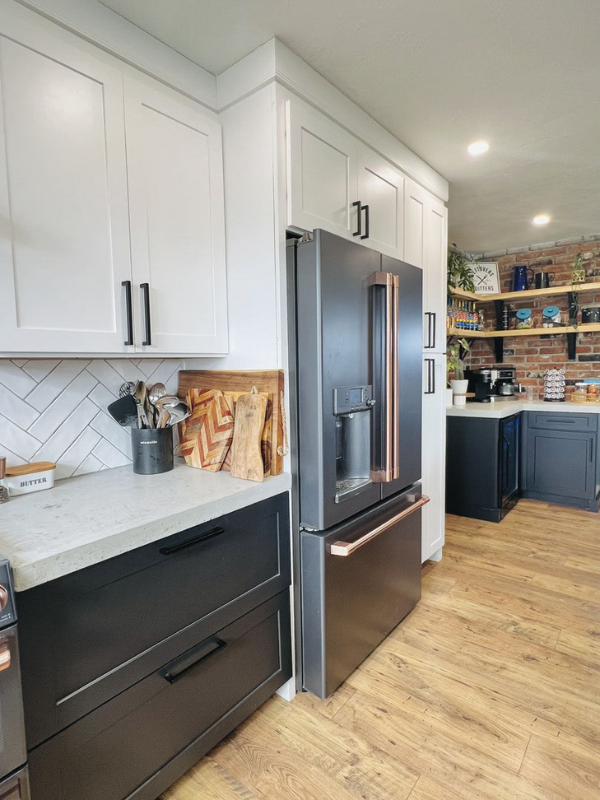 Modern white and black shaker kitchen design with white quartz countertops and black and gold appliances