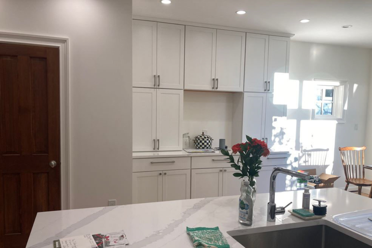 Stacked white shaker buffet cabinets with white quartz countertop