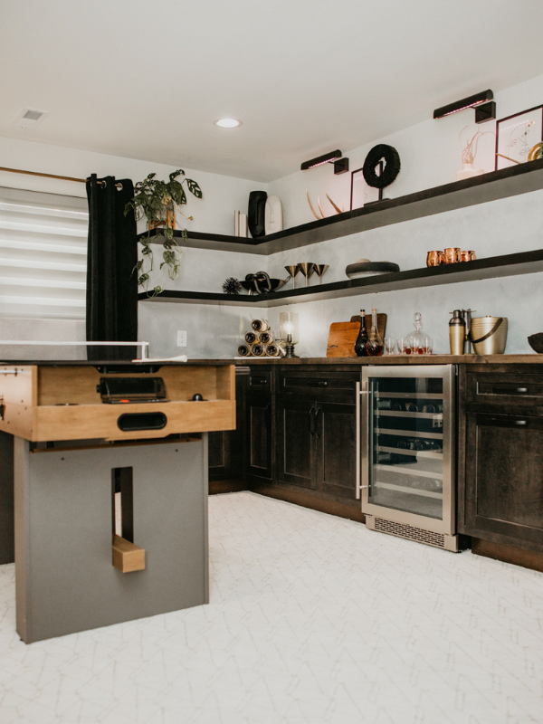 Basement bar cabinets in inset shaker door style in dark brown finish with floating shelves above