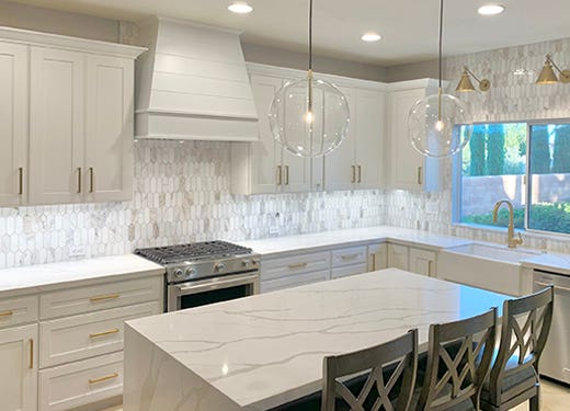 Tapered shiplap wood range hood in White against white shaker kitchen cabinets