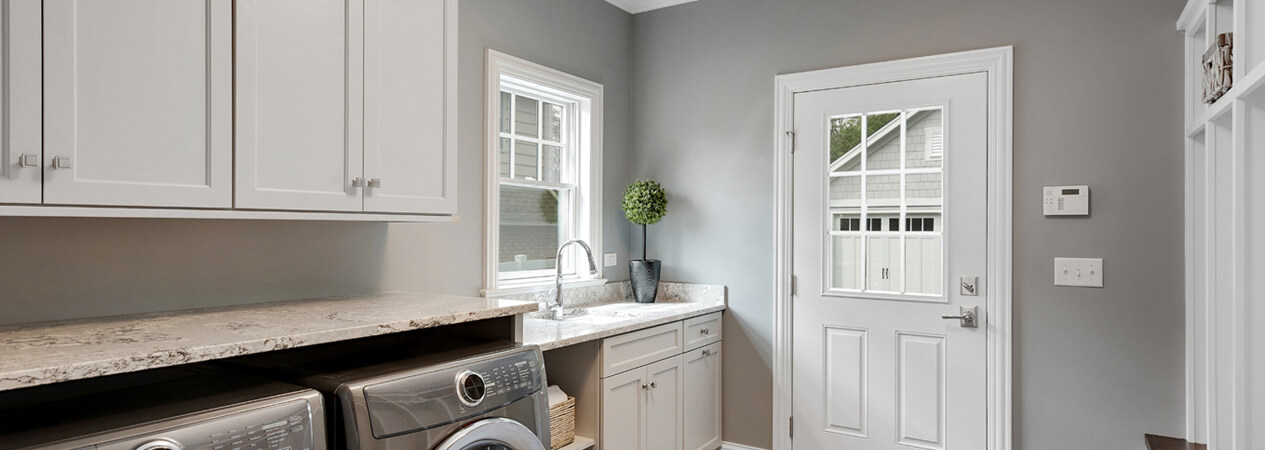 White shaker laundry room cabinets