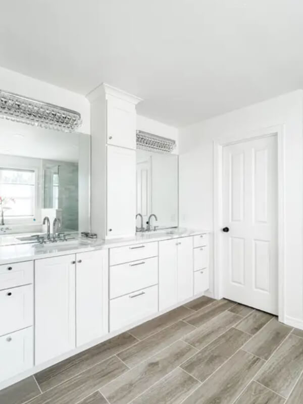 White shaker bathroom vanity with white countertops