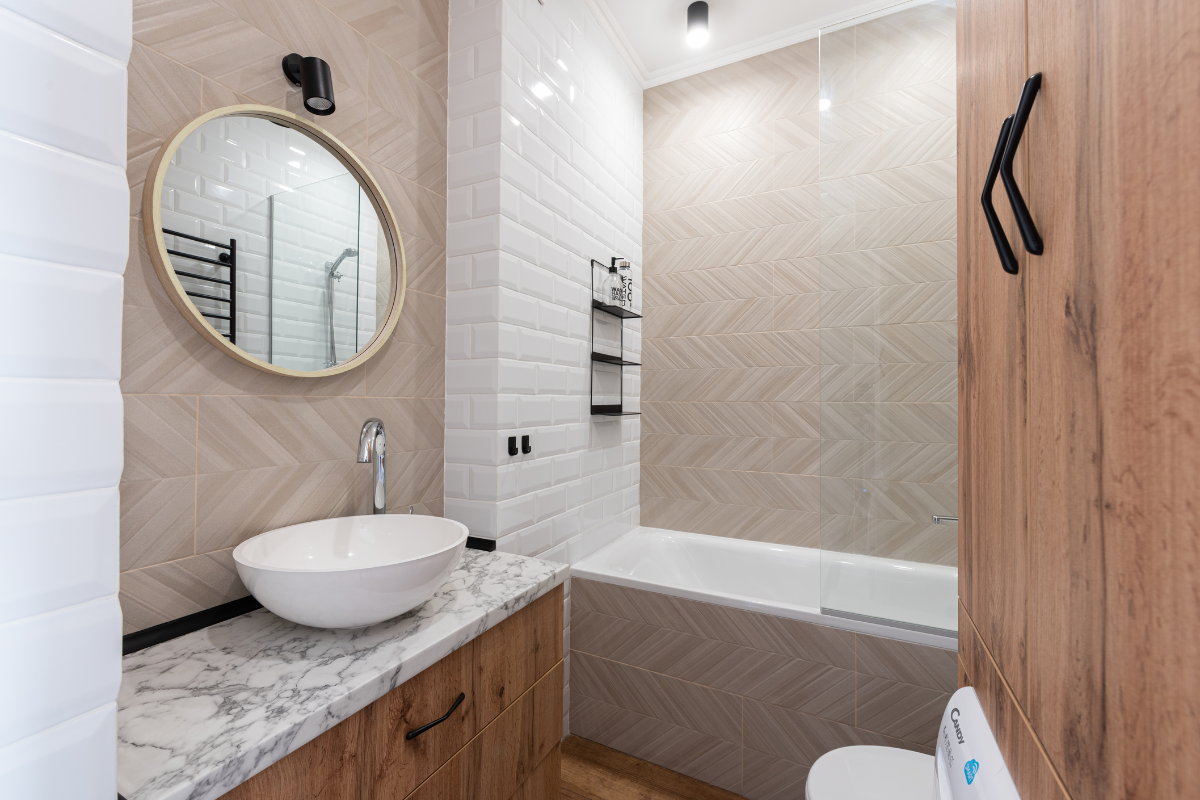 Modern organic bathroom remodel with white and neutral brown tones, a natural gray stone countertop and white vessel sink