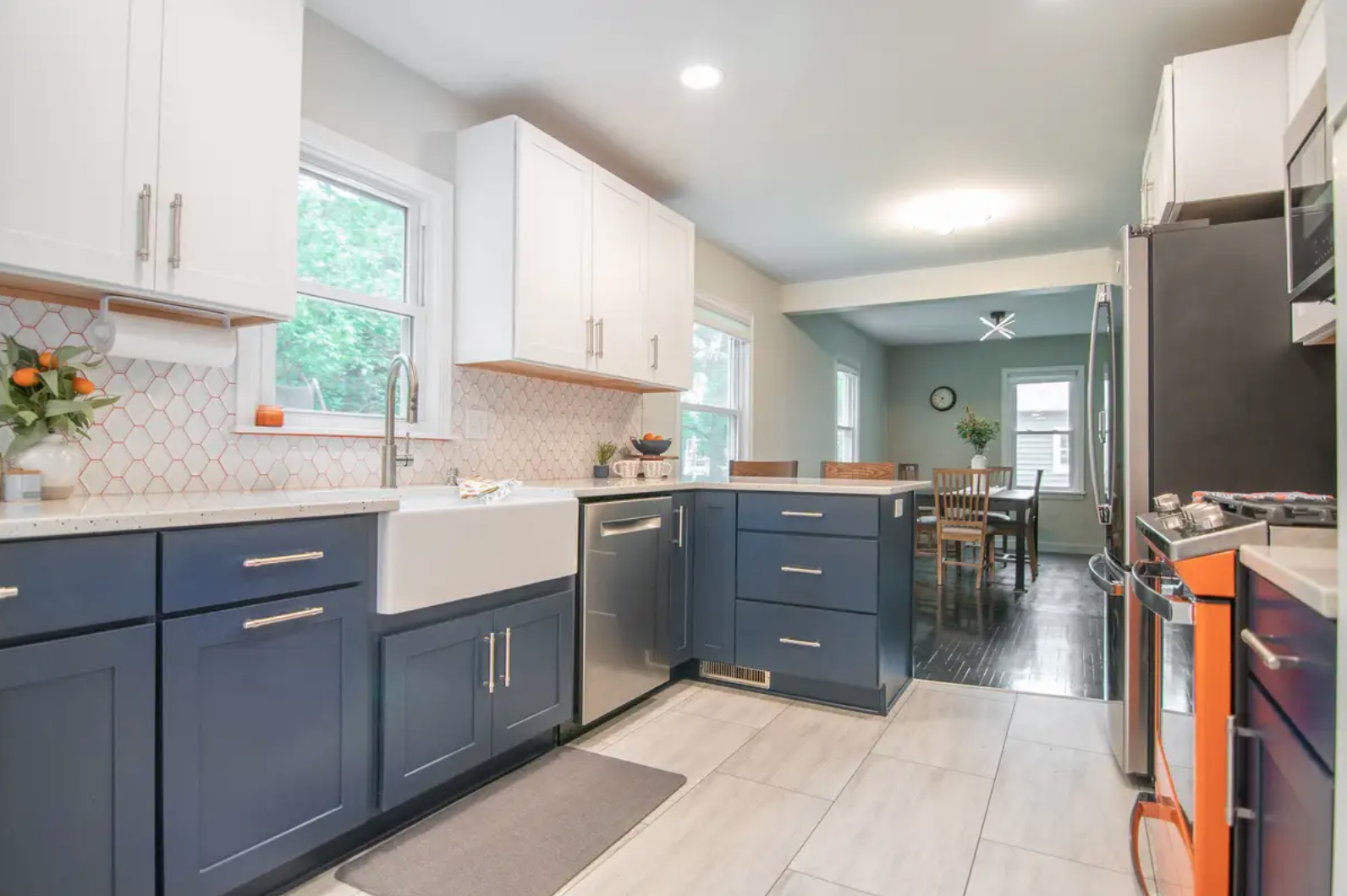 White and Navy Blue shaker kitchen cabinets with a bright orange range