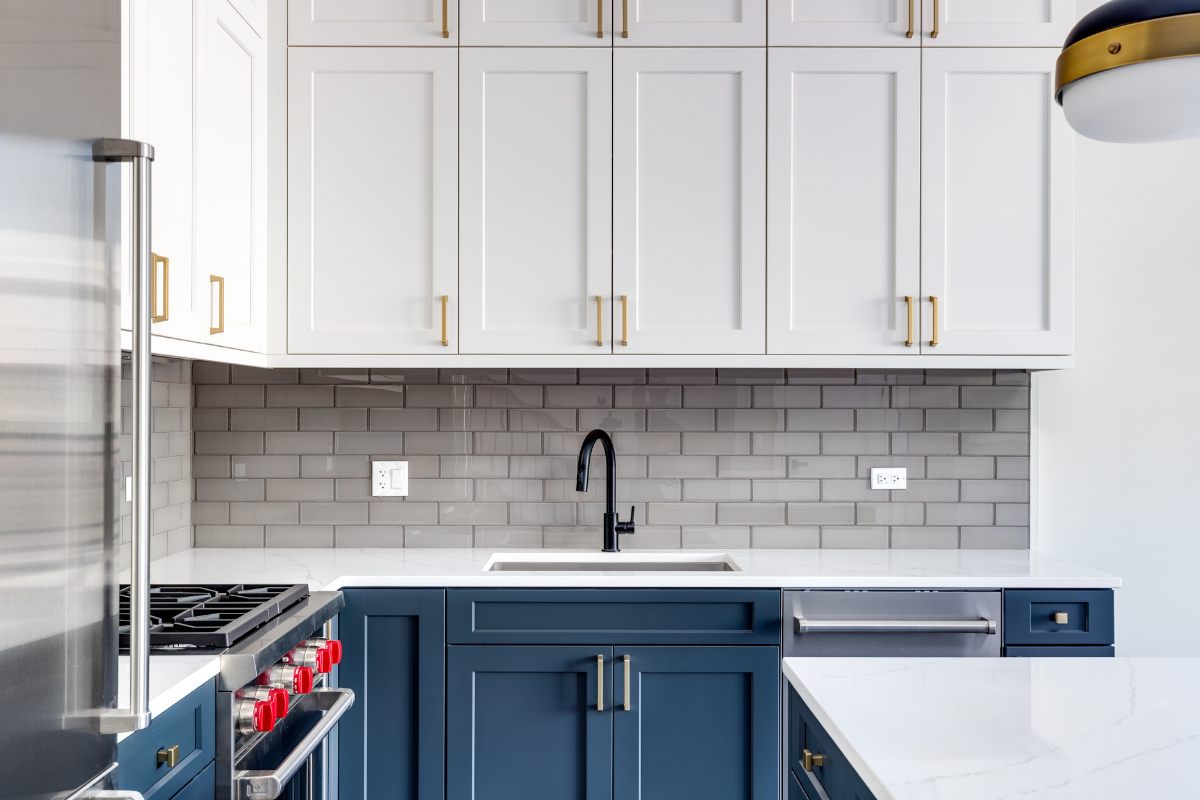 white and blue shaker kitchen cabinet design with gold hardware