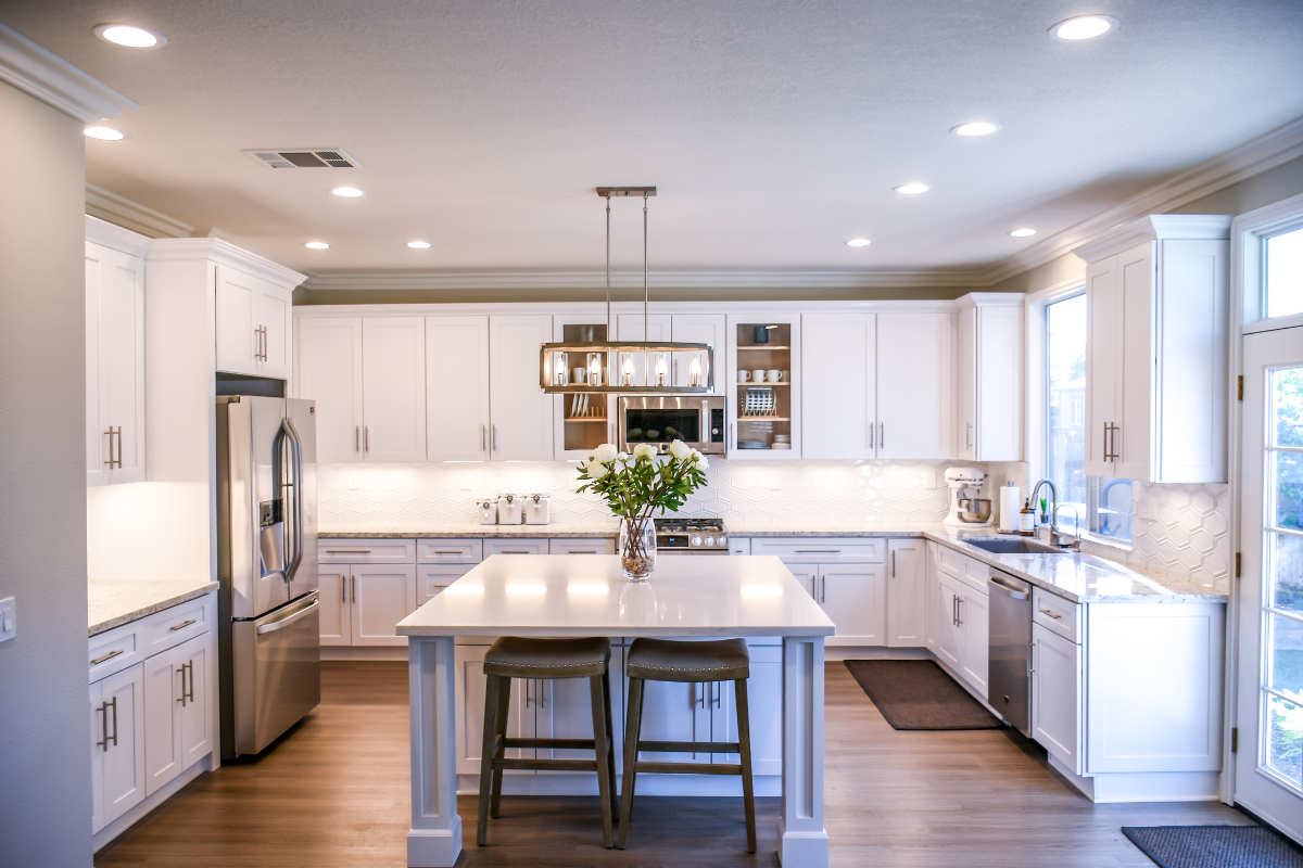 White shaker kitchen cabinet design with large center island and under cabinet lighting