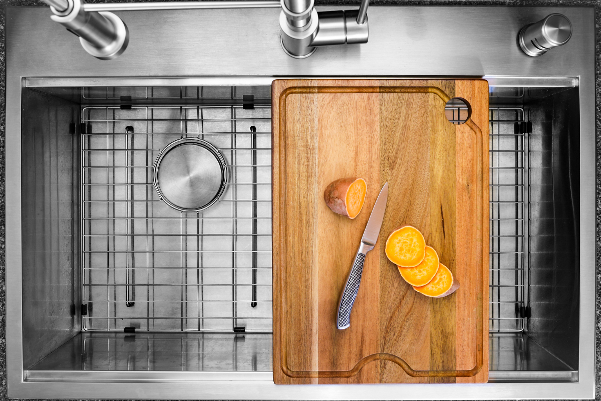 Stainless steel workstation kitchen sink with wooden cutting board on top