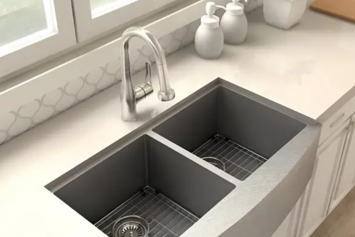 Chrome pull-down kitchen faucet on a stainless steel farm sink