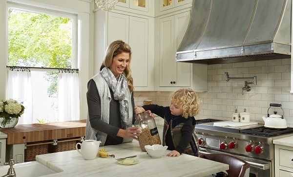 woman and small boy at center island in kitchen in older home