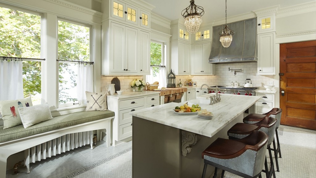 kithcen island built with green painted cabinets surrounded by painted white cabinets in historic home