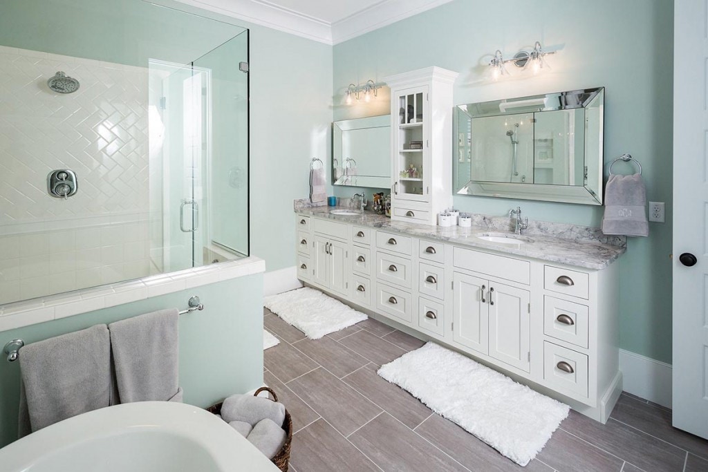 white shaker cabinets in double vanity with hutch in bath with glass shower and freestanding tub