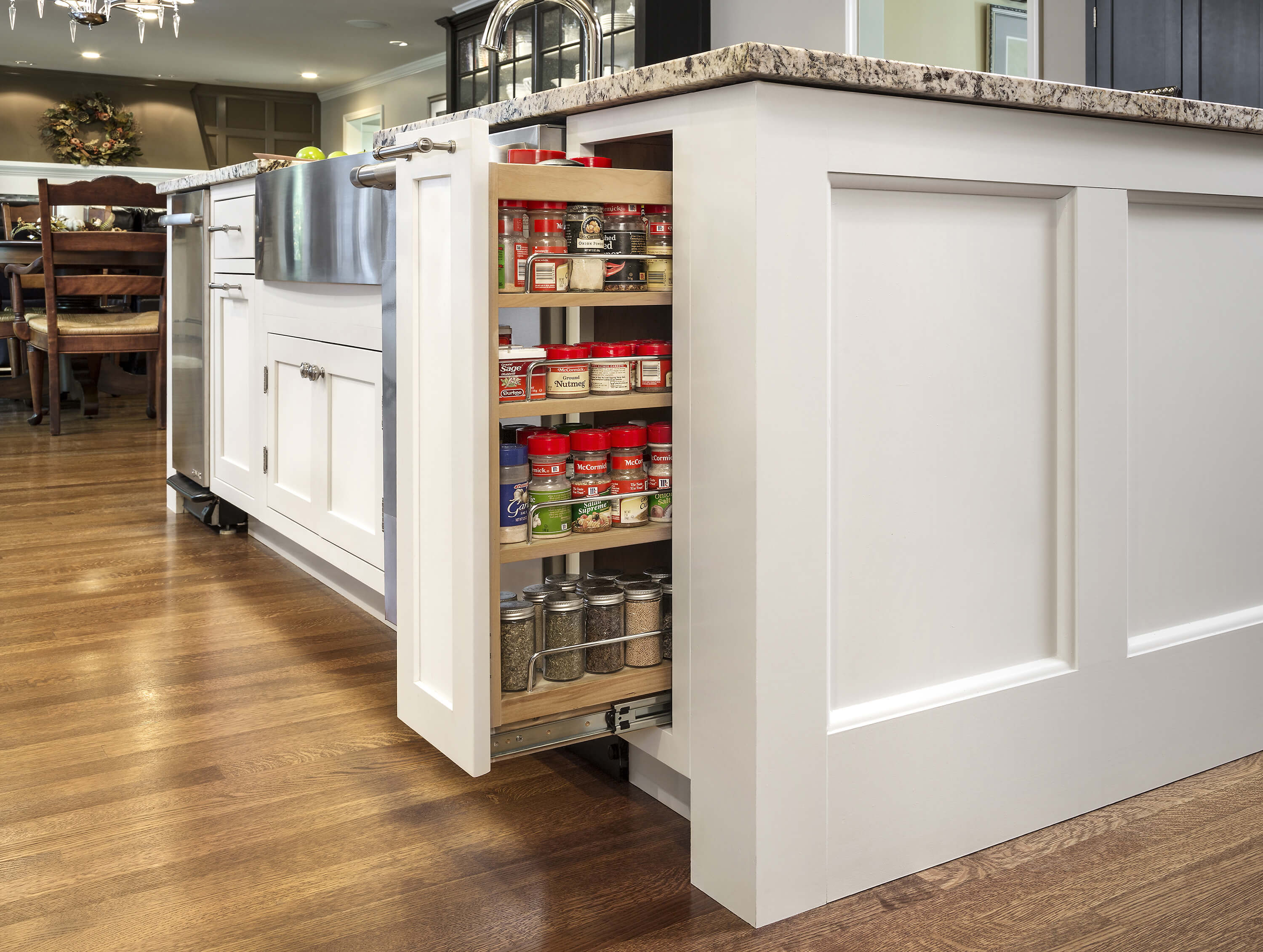 This image is of pull-out cabinet organizers that are a powerful addition to any kitchen design, especially where more storage space for pantry items is desperately needed.