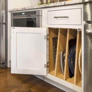 Tray divider base cabinet with a drawer above in a white shaker drawer style