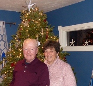 photo of CliqStudios customers Bob and RuthAnn Roth in front of a Christmas tree in their Cape Cod home