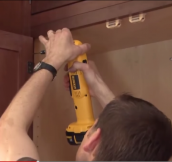 Kitchen Cabinet Installers - A man installing kitchen cabinets.