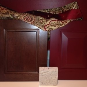 samples of cherry beaded cabinet door, red raised panel cabinet door, granite and fabric