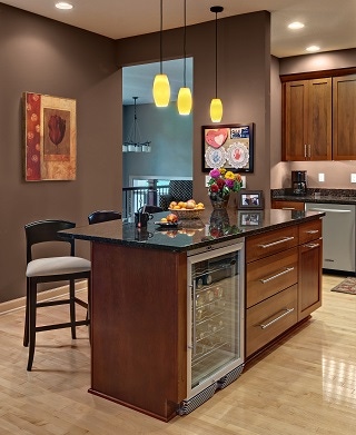 cherry kitchen island with black granite countertop and under-counter beverage cooler