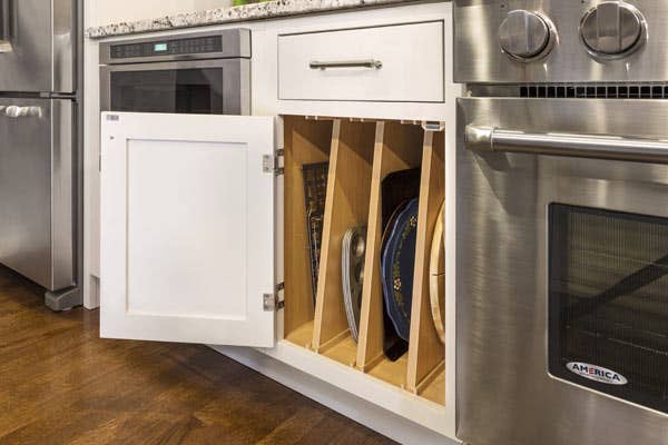 Tray divider installed in CliqStudios Shaker Inset base cabinet in White.