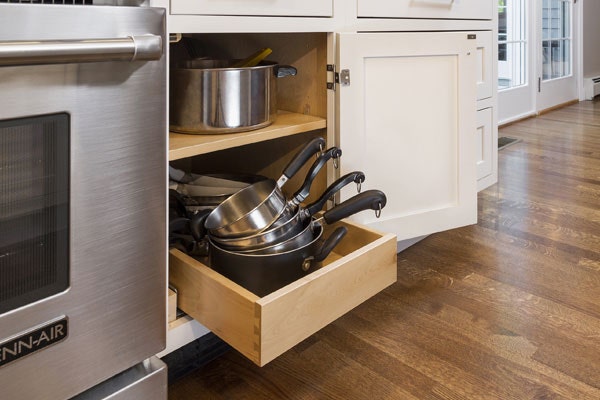 Single roll-out tray in a base cabinet, storing pots and saucepans. Shown in CliqStudios Shaker White.