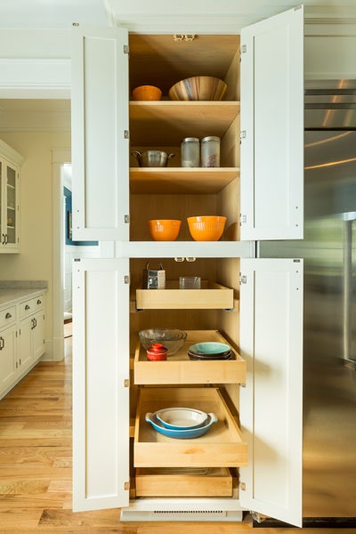 Tall pantry cabinet with upper shelves and bottom roll-out trays, shown in a Shaker style and White paint.