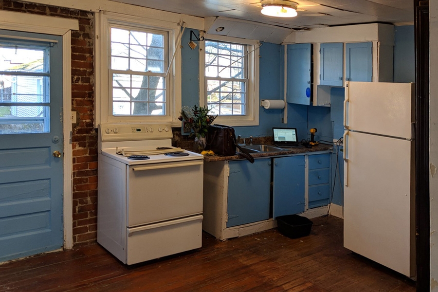 neglected old kitchen will blue cabinets that are falling apart