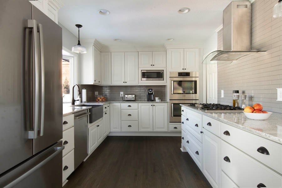 A kitchen using CliqStudios Decorative cabinets in White with dark floors.