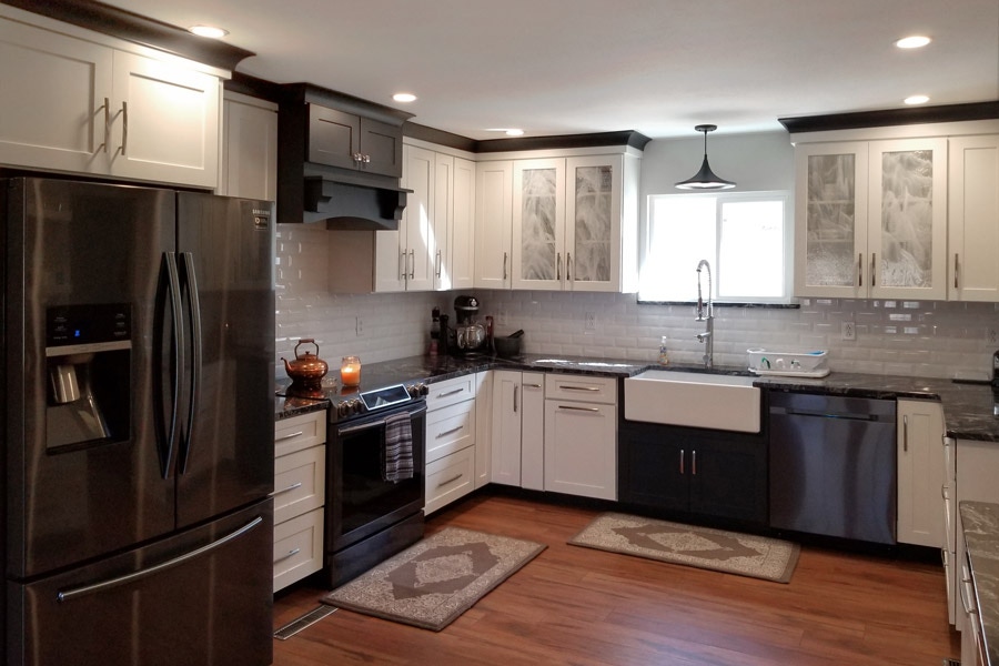 kitchen with white cabinets, and black accent cabinets and molding