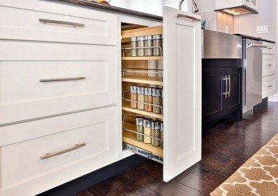 Smart storage solutions by CliqStudios keeps your kitchen organized with features such as this base cabinet with pull-out spice rack, shown here in shaker cabinet style in painted White finish.