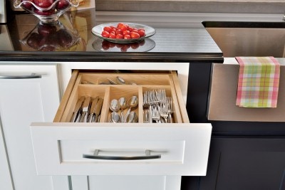 White Shaker cabinets feature silverware drawer with solid hardwood dividers and bottom on full-access glides