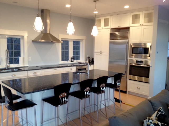 White shaker kitchen cabinets with black countertops