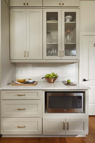 Light gray beverage bar in shaker kitchen cabinets