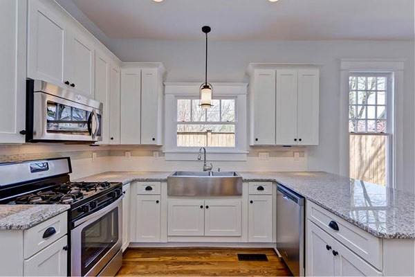 White shaker kitchen cabinets with a large peninsula