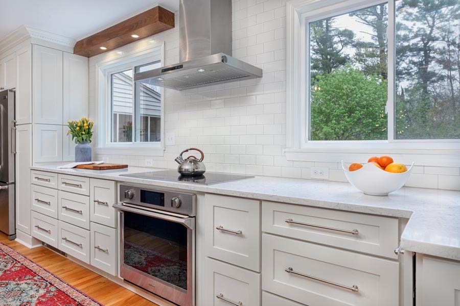 white shaker cabinet drawers surrounding range with a variety of drawer pull lengths