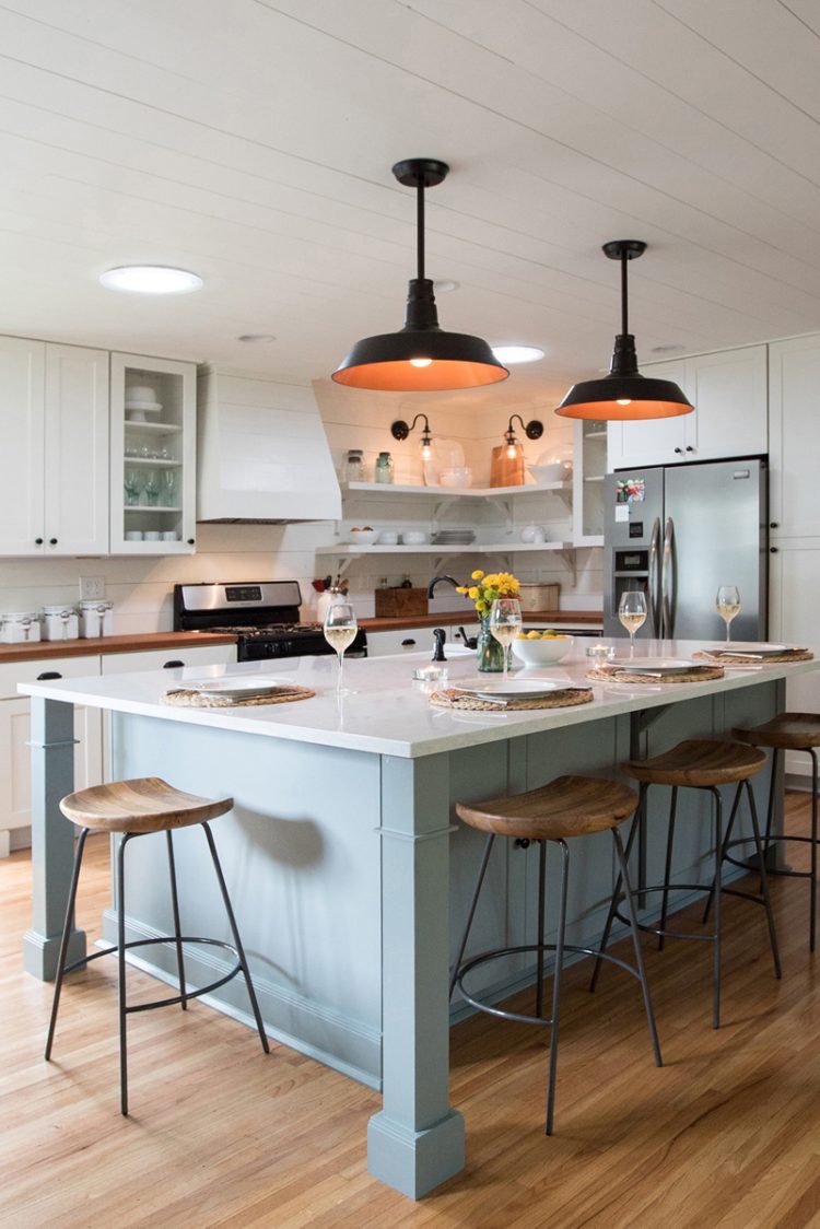 White and light gray shaker kitchen cabinets with shiplap wood range hood