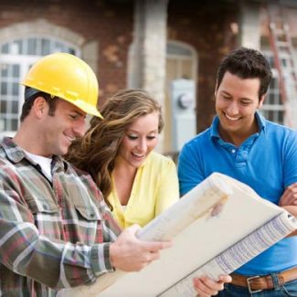 A man and a woman looking at blueprint with a contractor.