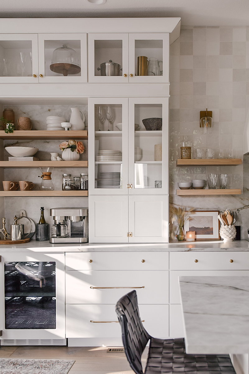 CliqStudios project: Painted white shaker buffet kitchen cabinet towers with natural wood floating shelves in between and three drawer base kitchen cabinets below