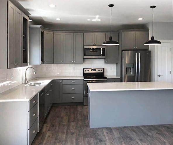 Open kitchen with island, gray cabinets, white countertops and subway tile backsplash