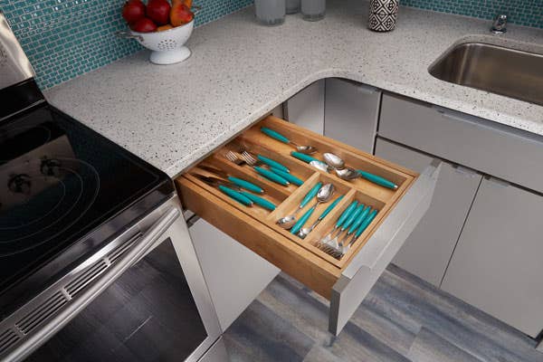 Tiered drawer insert in Slab door and Painted Medium Gray with the second tier storing silverware closed