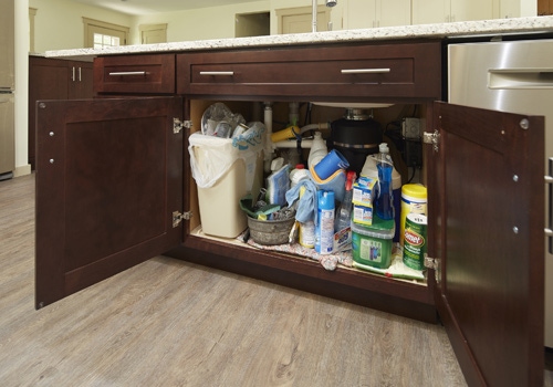 Shaker in medium wood stain as the super sink base before being organized