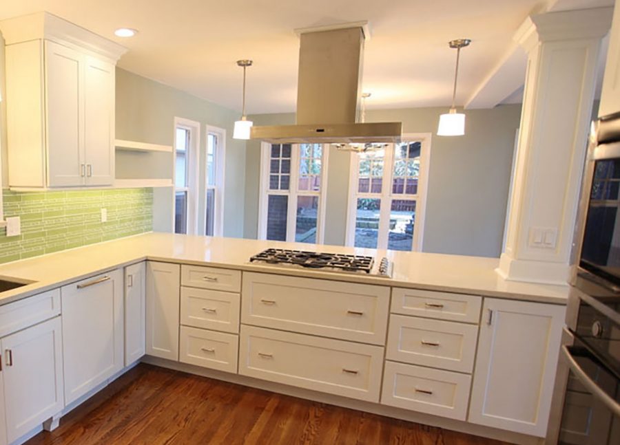 Cooktop peninsula with pillar, stainless hood and drawer bases