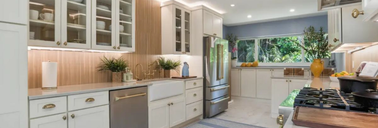 Galley-style white shaker kitchen design with wood slat backsplash and white stone countertops