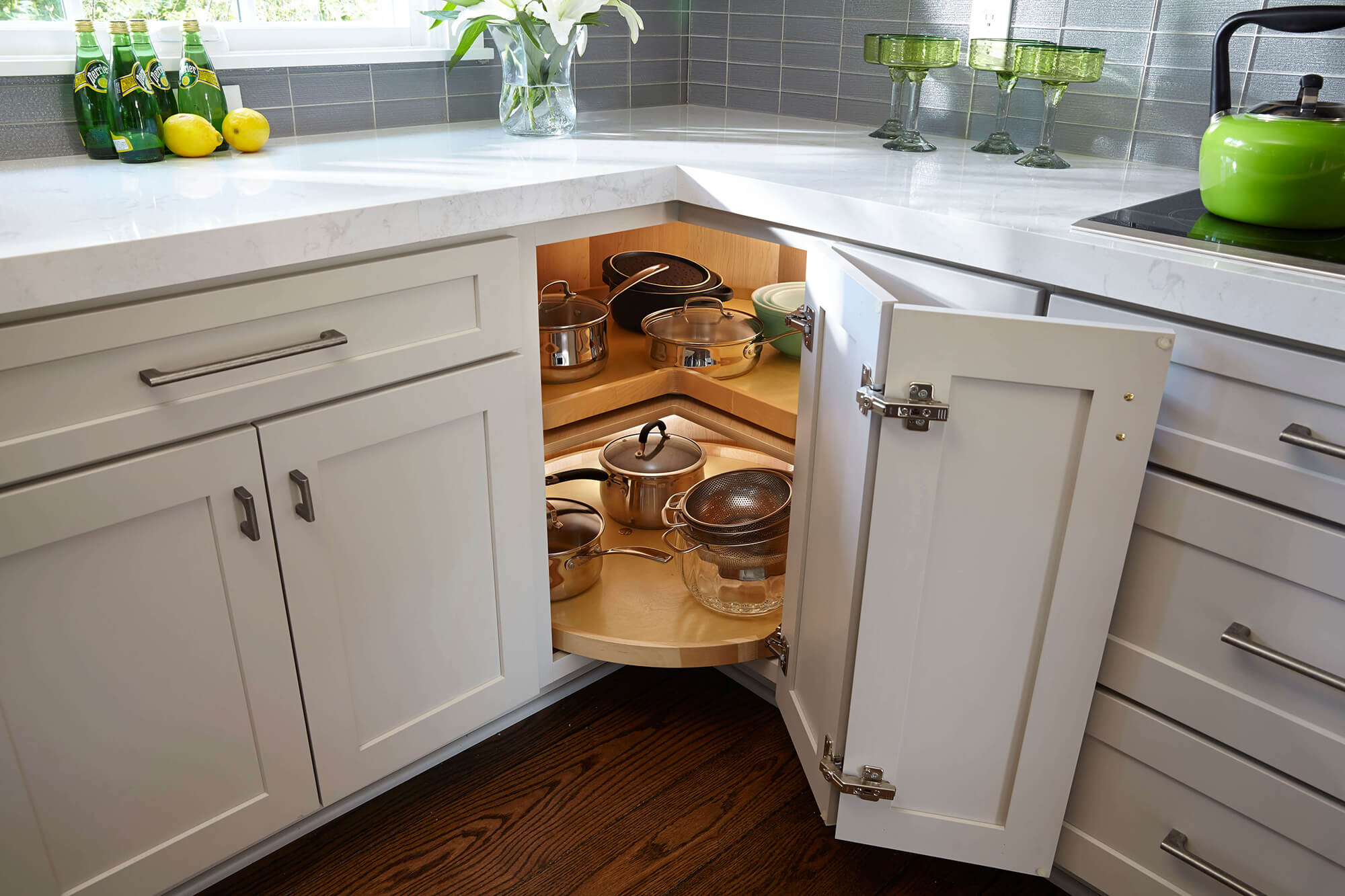 The image is of White Corner Cabinet. Corner cabinets are versatile and offer extra storage space throughout the home- space