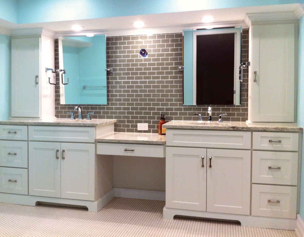 Master bathroom with white shaker vanity cabinets, two sinks and a makeup station