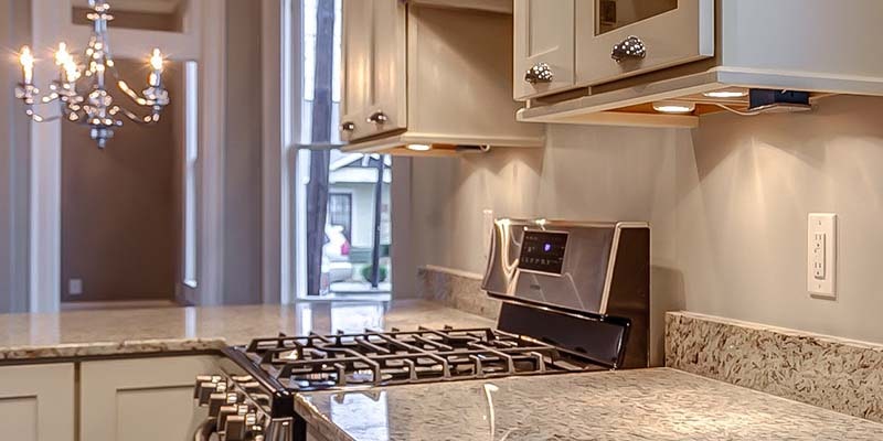 Shaker cabinets painted white with shaker lightrail and puck lighting underneath